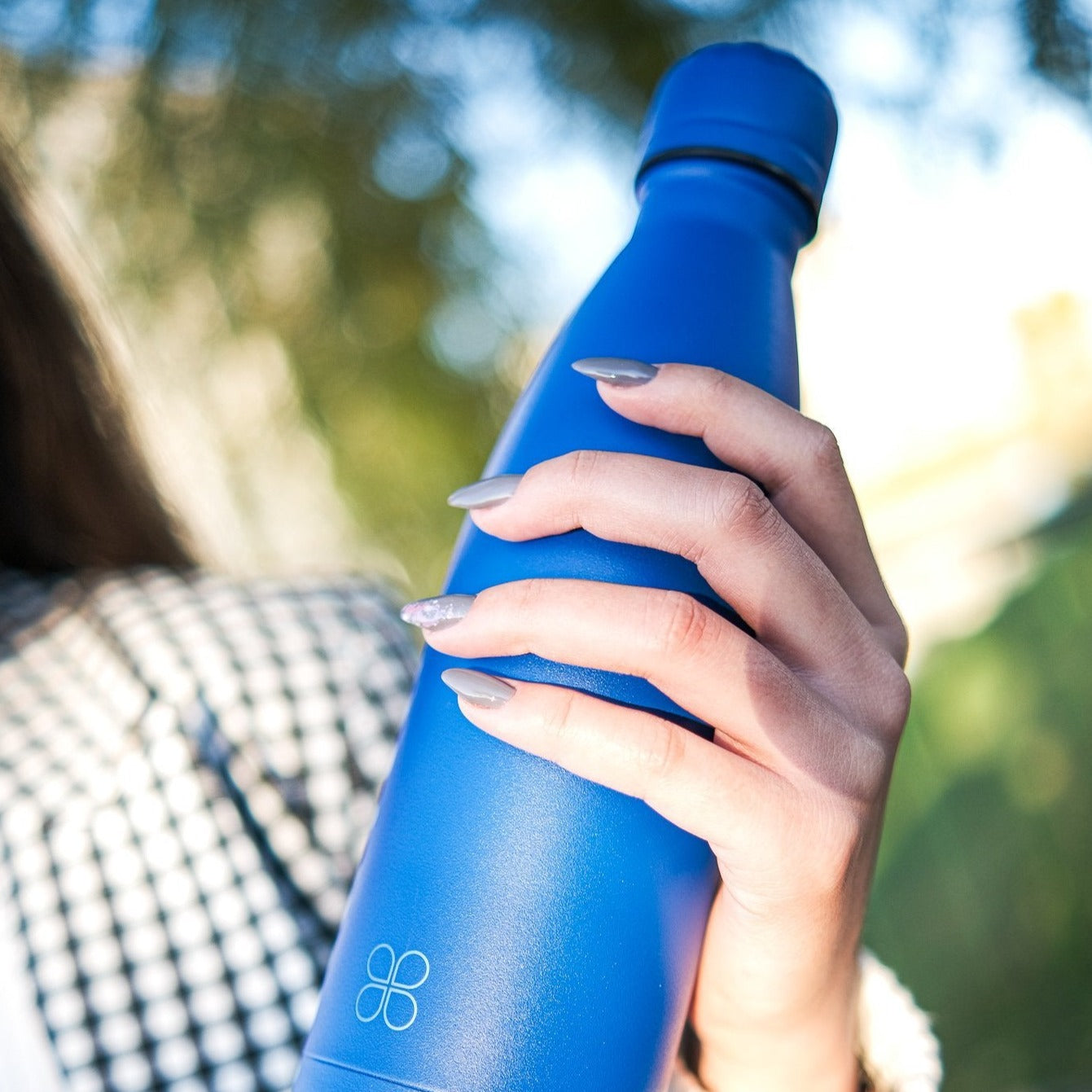 Blue Water Bottle Held By A Lady