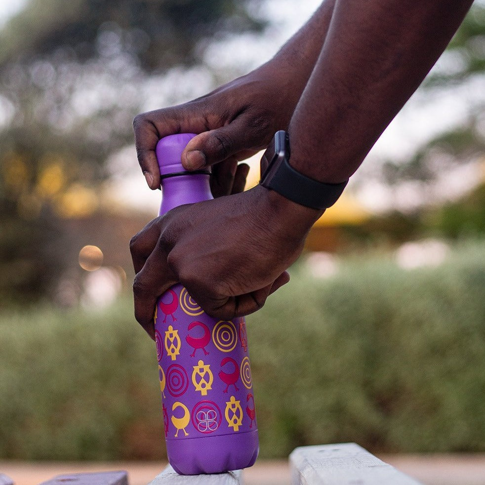 Man opening a Purple Metal Water Bottle