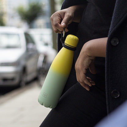 Lady  in Black holds Green Stainless Steel Water Bottle